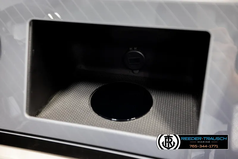 Slide: The Image of 2026 Avalon Excal LTD CRB storage compartment with textured interior and Reeder-Trausch Marine logo. - 38