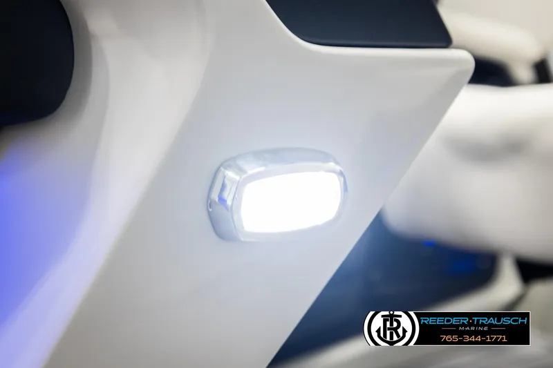 Slide: The Image of Close-up of 2026 Avalon Excal LTD CRB boat light, featuring sleek white design. - 46