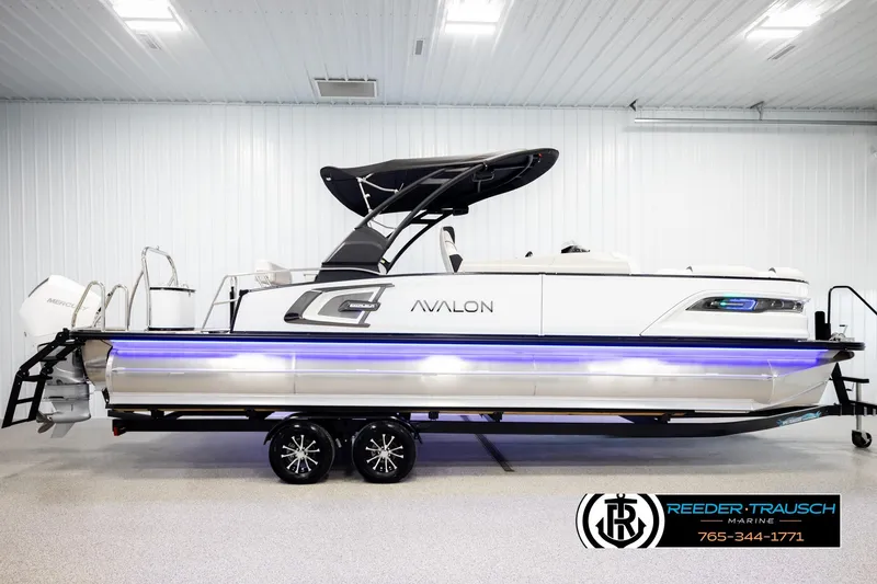 Slide: The Image of 2026 Avalon Excal LTD CRB boat with sleek design and modern features in showroom. - 5