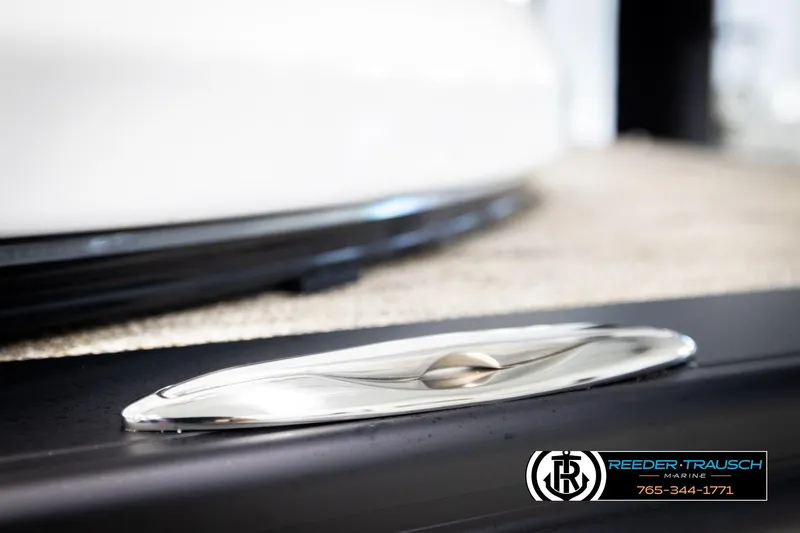 Slide: The Image of 2026 Avalon Excal LTD CRB boat detail with sleek chrome finish, Reeder-Trausch Marine branding. - 59