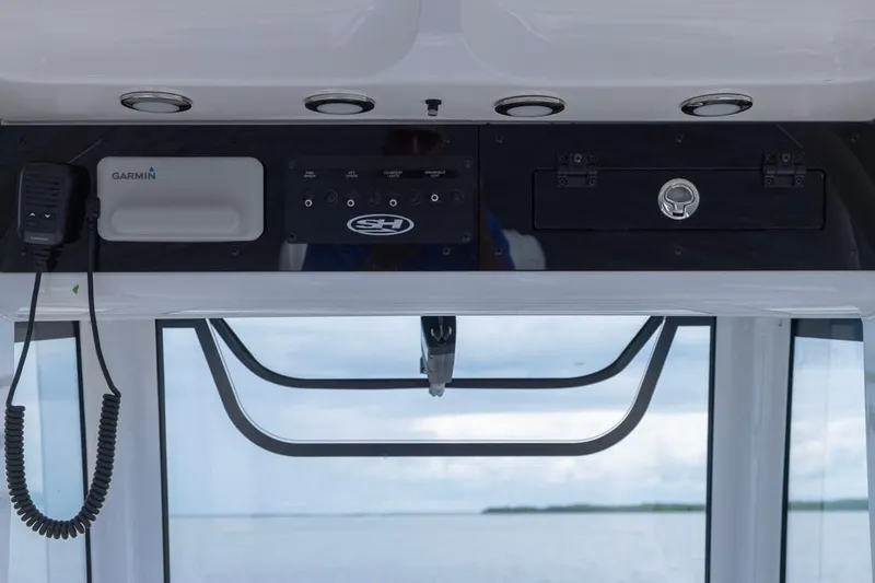 Slide: The Image of 2026 Sea Hunt Ultra 265 SE dashboard with Garmin equipment and ocean view. - 10