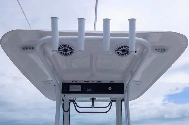 Slide: The Image of T-top of 2026 Sea Hunt Ultra 265 SE boat with rod holders and speakers. - 11