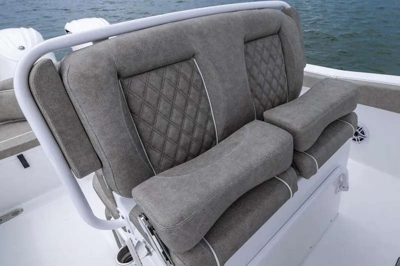 Slide: The Image of Luxury seating on 2026 Sea Hunt Ultra 265 SE boat, featuring plush gray upholstery. - 12