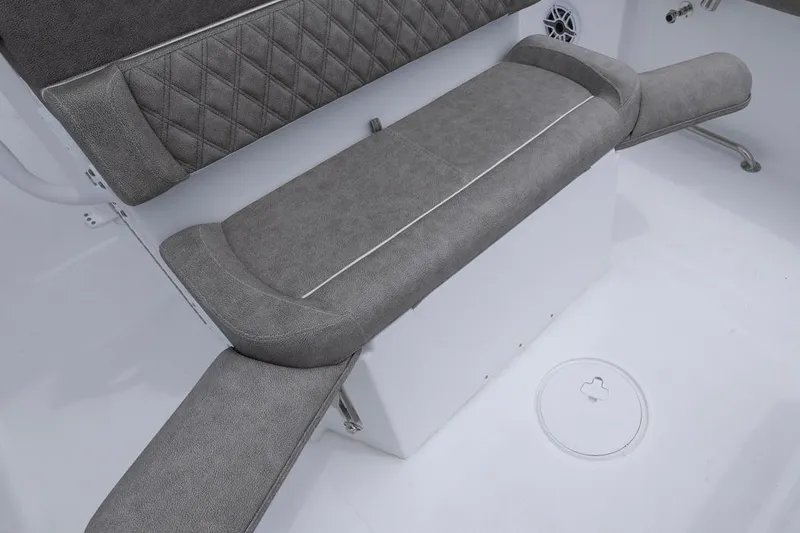 Slide: The Image of 2026 Sea Hunt Ultra 265 SE boat interior with gray cushioned seating. - 15