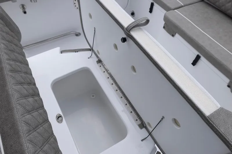 Slide: The Image of Interior view of 2026 Sea Hunt Ultra 265 SE boat, featuring seating and storage area. - 16