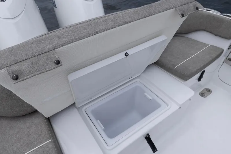 Slide: The Image of 2026 Sea Hunt Ultra 265 SE boat with open storage compartment and cushioned seating. - 21