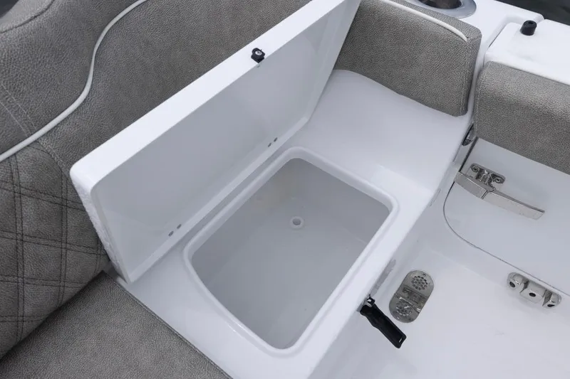 Slide: The Image of Open storage compartment on 2026 Sea Hunt Ultra 265 SE boat, featuring cushioned seating. - 22