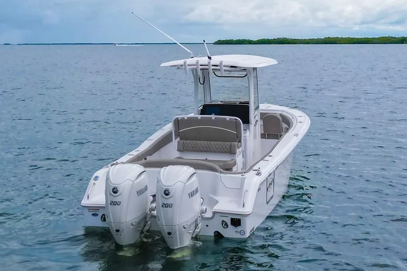 Slide: The Image of 2026 Sea Hunt Ultra 265 SE boat with dual Yamaha engines on open water. - 4