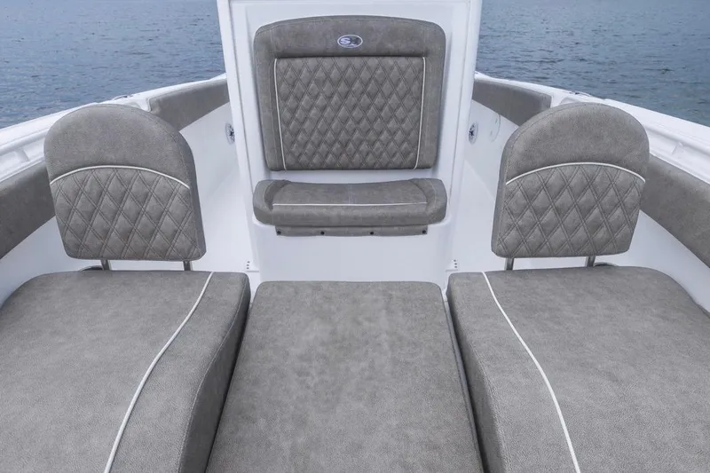 Slide: The Image of 2026 Sea Hunt Ultra 265 SE boat interior with gray cushioned seating. - 6
