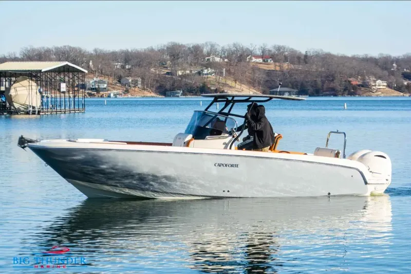 The Image of 2024 Capoforte FX270 boat cruising on a serene lake with scenic background. - 1