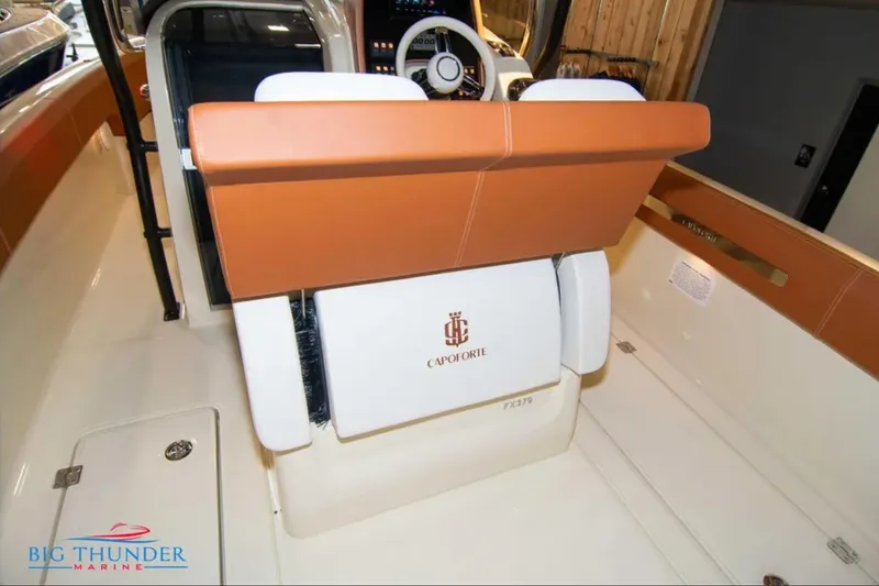 Slide: The Image of 2024 Capoforte FX270 boat interior with tan and white seating, steering wheel visible. - 10