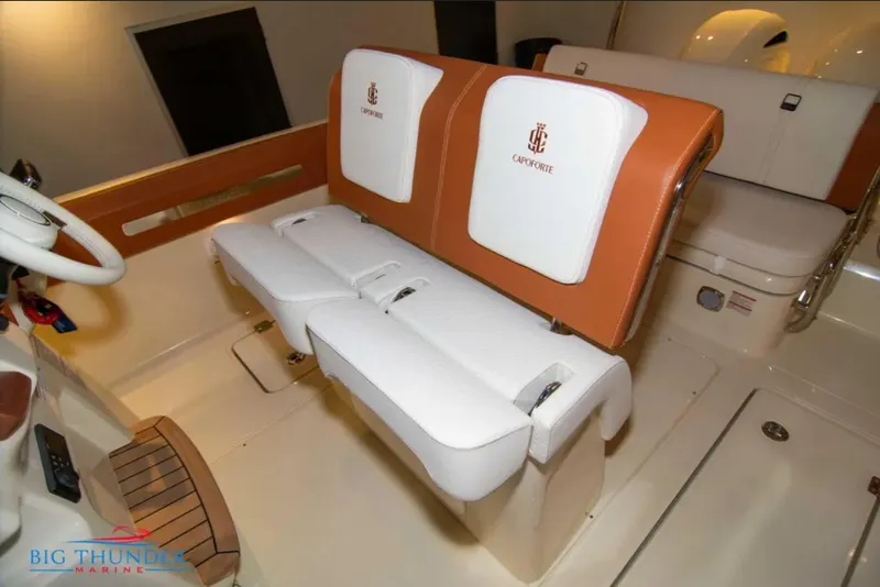 Slide: The Image of 2024 Capoforte FX270 boat interior with white and tan seating, featuring logo embroidery. - 22
