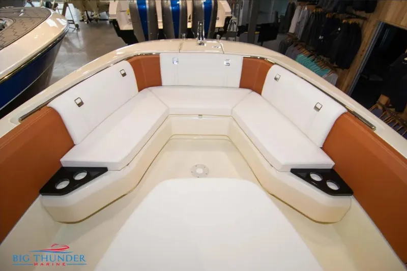 Slide: The Image of 2024 Capoforte FX270 boat interior with white and orange seating, cup holders, and sleek design. - 25