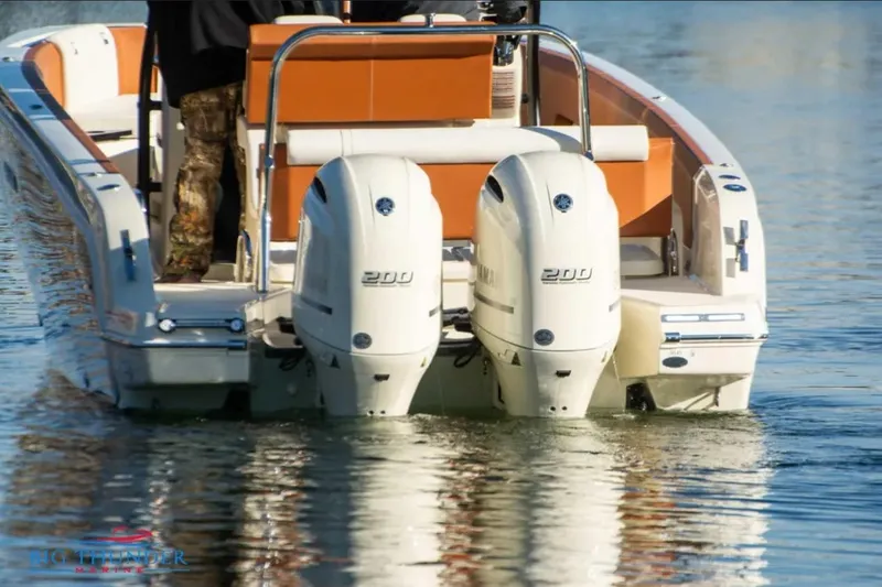 Slide: The Image of 2024 Capoforte FX270 boat with dual 200 horsepower engines on calm water. - 3