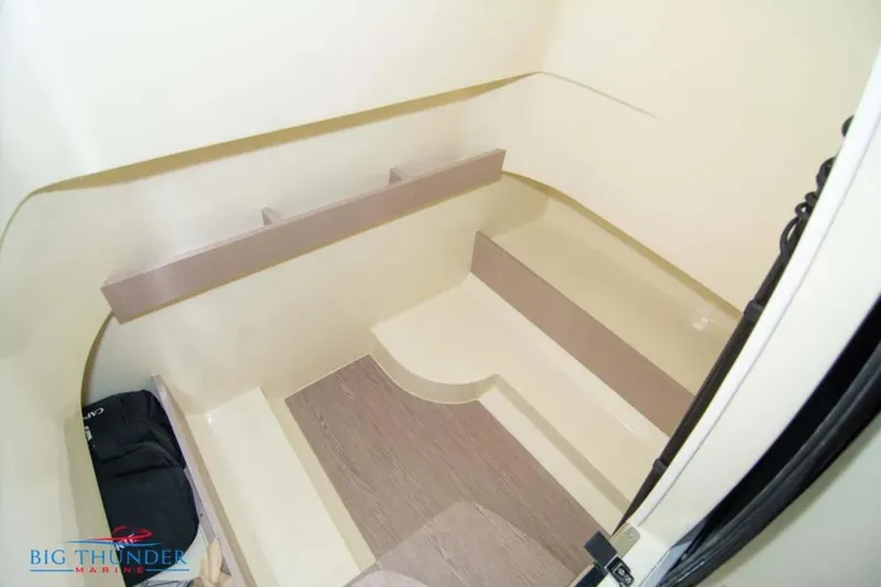 Slide: The Image of Interior cabin of 2024 Capoforte FX270 boat, featuring sleek beige design and wooden flooring. - 30