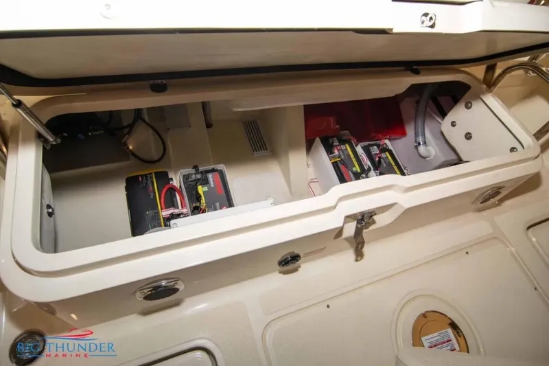 Slide: The Image of 2024 Capoforte FX270 boat battery compartment with wiring and storage. - 31