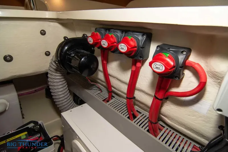 Slide: The Image of 2024 Capoforte FX270 boat electrical system with red battery switches and wiring. - 33