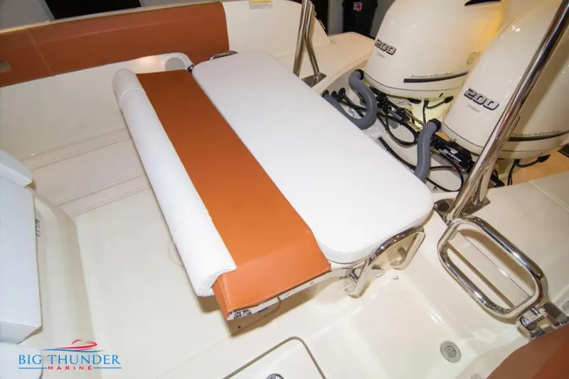 Slide: The Image of 2024 Capoforte FX270 boat interior with seating and dual 200 horsepower engines. - 8
