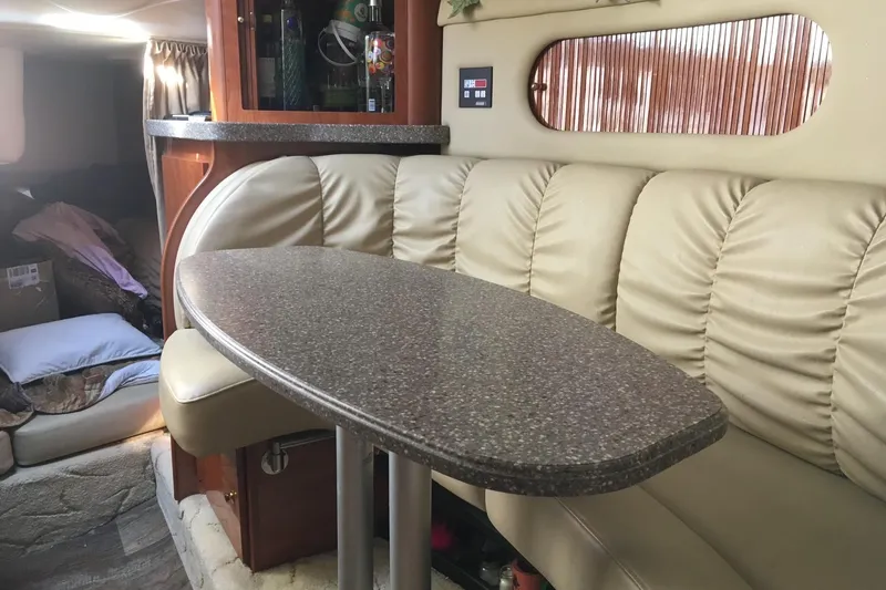 Slide: The Image of Control panel of a 2004 Rinker Fiesta Vee 312 boat, featuring various switches and gauges. - 3