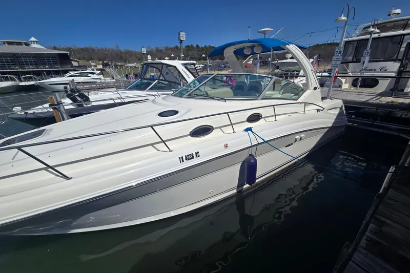 Slide: The Image of 2003 Sea Ray 340 Sundancer docked at a marina under clear blue skies. - 10