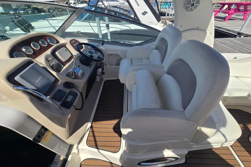 Slide: The Image of 2003 Sea Ray 340 Sundancer helm with dual seats and modern controls. - 12