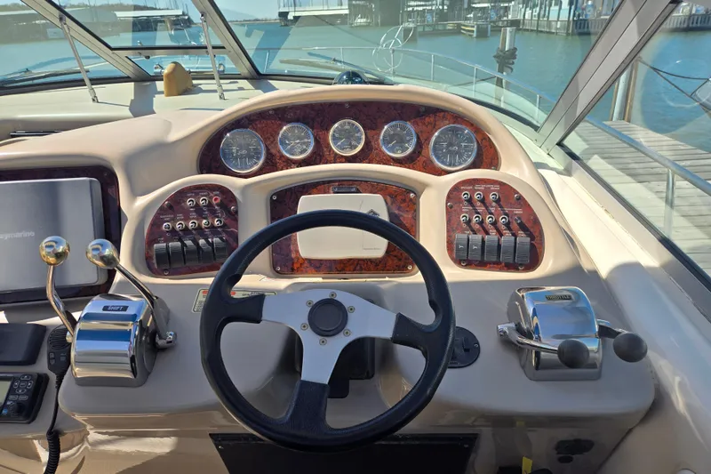Slide: The Image of Helm of 2003 Sea Ray 340 Sundancer with steering wheel, gauges, and controls. - 13