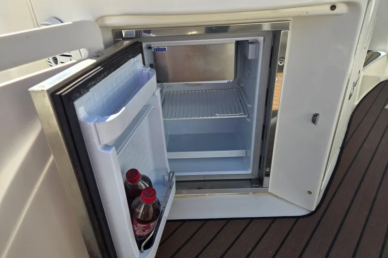 Slide: The Image of Open mini fridge on 2003 Sea Ray 340 Sundancer boat with two soda bottles inside. - 15