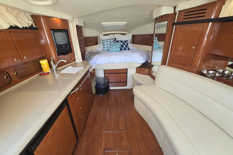 Slide: The Image of Luxurious 2003 Sea Ray 340 Sundancer cabin interior with kitchenette, seating, and bed. - 18
