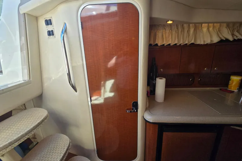 Slide: The Image of Interior of 2003 Sea Ray 340 Sundancer with wooden door and compact kitchenette. - 19