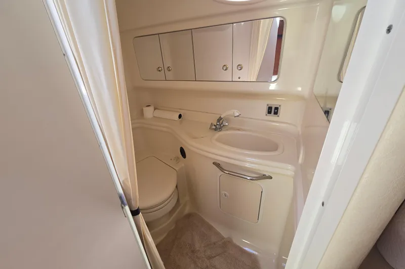Slide: The Image of 2003 Sea Ray 340 Sundancer bathroom with sink, toilet, and storage cabinets. - 20