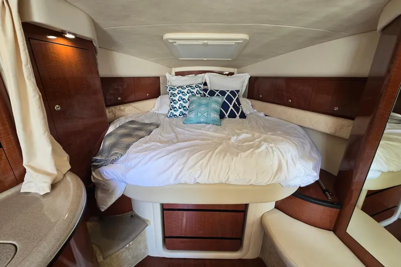 Slide: The Image of Luxurious cabin interior of 2003 Sea Ray 340 Sundancer with cozy bed and elegant wood finish. - 22