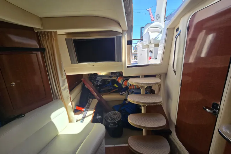 Slide: The Image of Interior of 2003 Sea Ray 340 Sundancer with seating, steps, and a TV. - 24