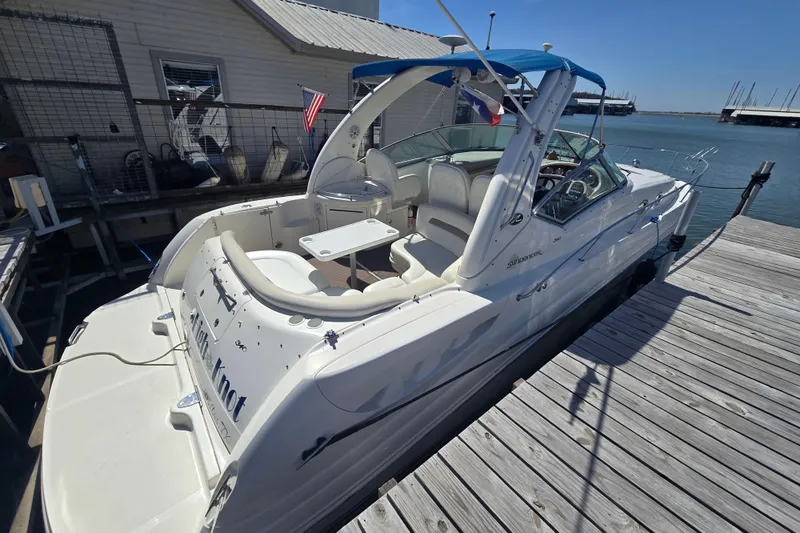 Slide: The Image of 2003 Sea Ray 340 Sundancer docked, featuring spacious seating and sleek design. - 3