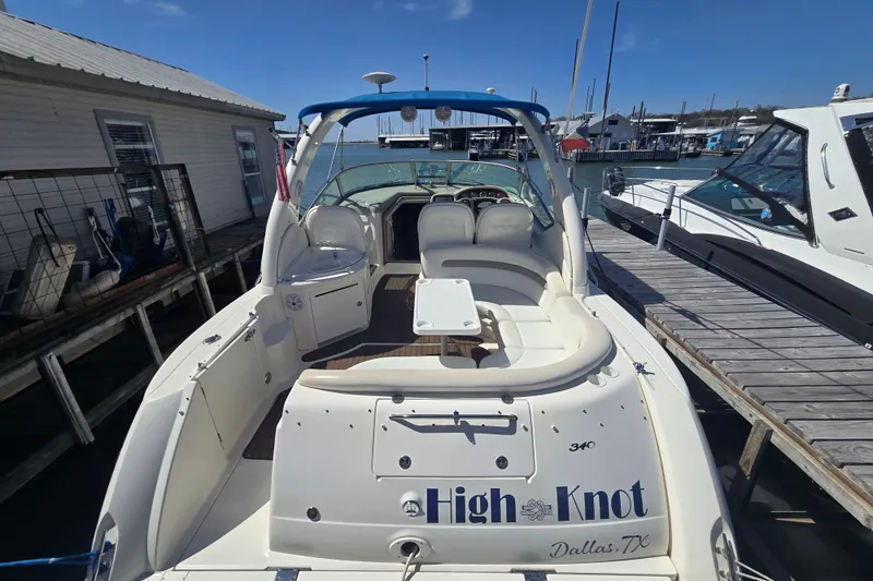 Slide: The Image of 2003 Sea Ray 340 Sundancer docked, featuring spacious seating and a sleek design. - 8