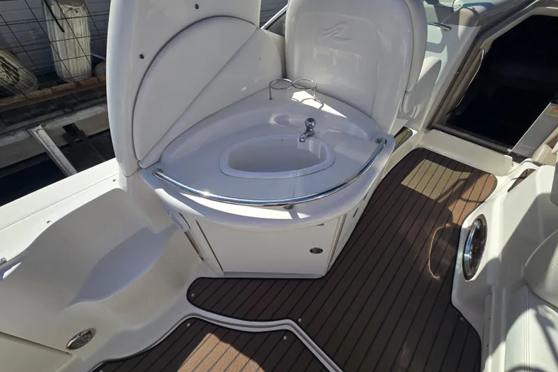 Slide: The Image of 2003 Sea Ray 340 Sundancer boat interior with sink and wooden flooring. - 9