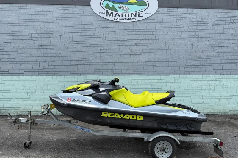 The Image of 2021 Seadoo GTI SE 130 with Sound System on trailer, parked outside marine service shop. - 1