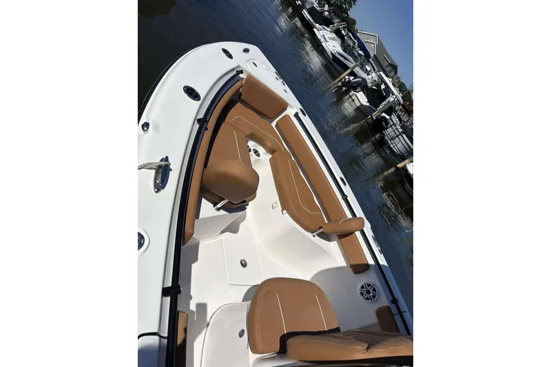 Slide: The Image of 2026 Key West 239 FS boat with tan seating, docked in a marina. - 13