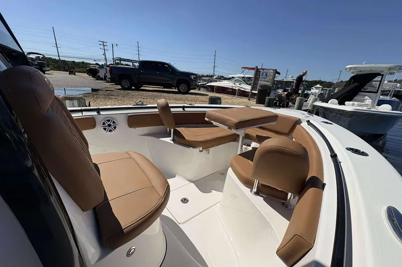 Slide: The Image of 2026 Key West 239 FS boat interior with tan seating, docked at marina. - 14