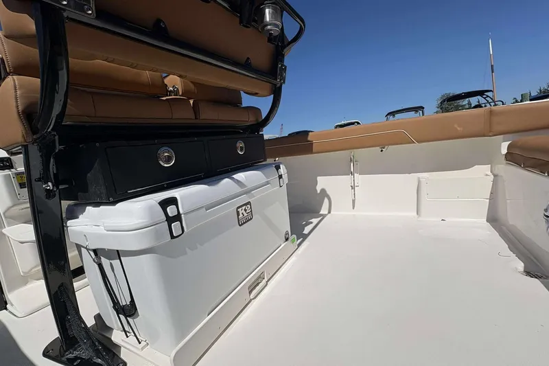 Slide: The Image of 2026 Key West 239 FS boat interior with seating and storage, featuring a K2 cooler. - 18