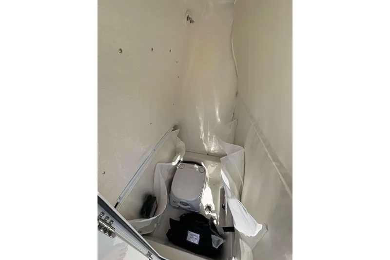 Slide: The Image of Interior of 2026 Key West 239 FS boat, featuring compact marine toilet setup. - 21