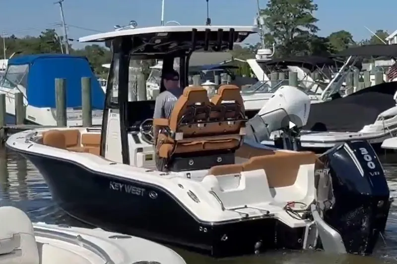 Slide: The Image of 2026 Key West 239 FS boat docked, featuring sleek design and powerful engine. - 7