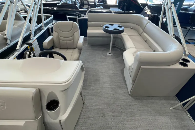 Slide: The Image of 2026 Godfrey Xperience 2086 CX pontoon boat interior with plush seating and steering console. - 11