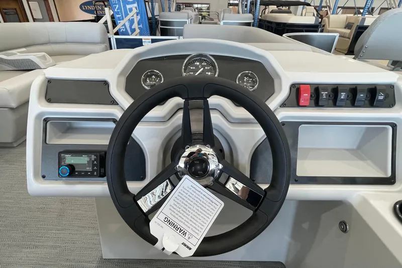 Slide: The Image of 2026 Godfrey Xperience 2086 CX boat dashboard with steering wheel and control panel. - 8