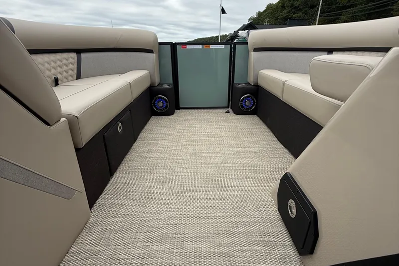 Slide: The Image of 2026 Crest 230 SLSC boat interior with beige seating and carpeted flooring. - 10