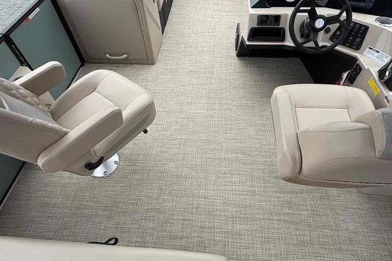 Slide: The Image of 2026 Crest 230 SLSC boat interior with beige seating and modern dashboard. - 7