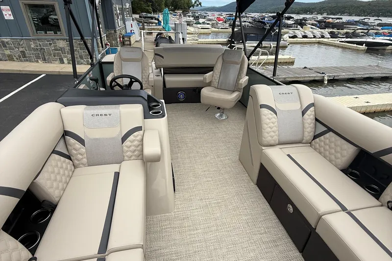 Slide: The Image of Luxurious interior of 2026 Crest 230 SLSC pontoon boat at marina dock. - 9