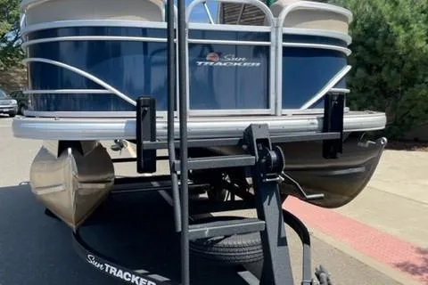 Slide: The Image of 2022 Sun Tracker Party Barge 20 DLX pontoon boat on trailer, parked outdoors. - 12