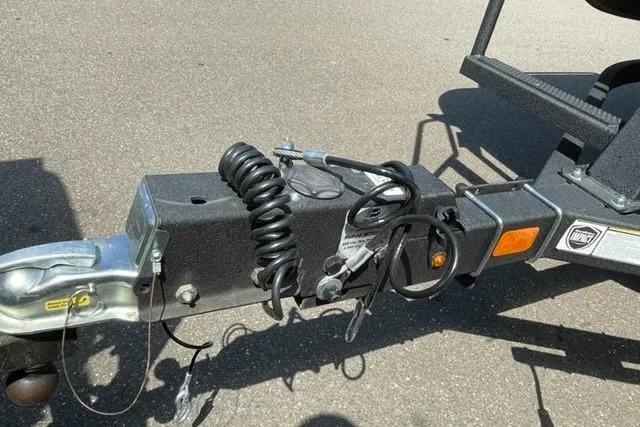 Slide: The Image of Trailer hitch of 2022 Sun Tracker Party Barge 20 DLX on asphalt surface. - 14