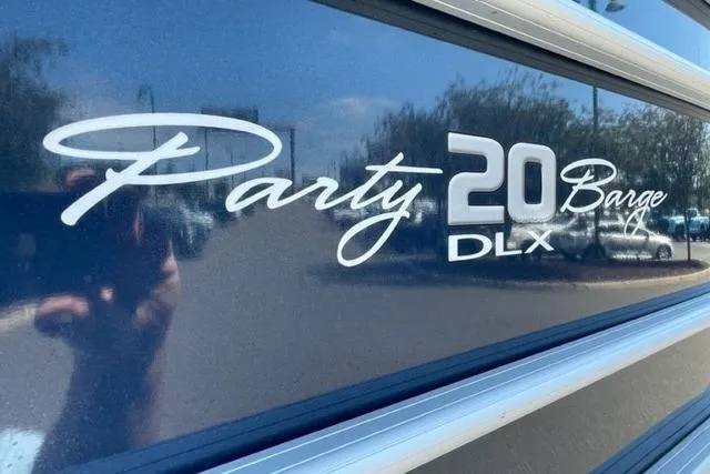 Slide: The Image of 2022 Sun Tracker Party Barge 20 DLX logo on a reflective surface. - 5