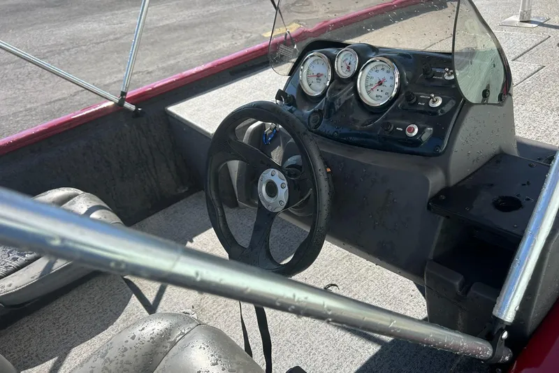 Slide: The Image of 2020 Bass Tracker Pro 170 boat interior with steering wheel and dashboard gauges. - 5